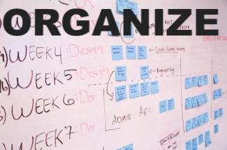 a whiteboard with organization post its and the word organize in block letters